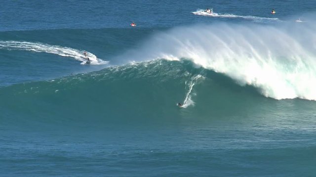 Surfers at the big wave surfing break Jaws in at the north shore of the island of Maui, Hawaii