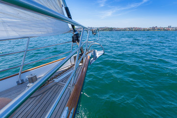 Fototapeta na wymiar Close of a bow of a yacht sailing on clear blue aqua waters on a sunny day in summer