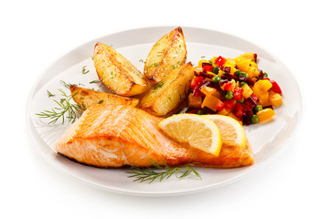 Fried salmon and vegetables on white background 