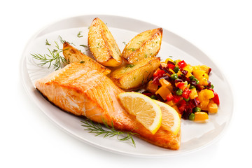 Fried salmon and vegetables on white background 