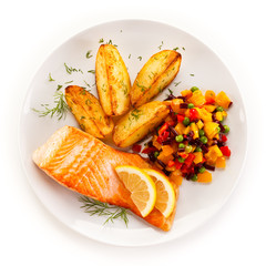 Fried salmon and vegetables on white background 