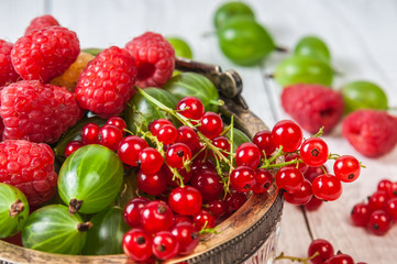 Mix of fresh organic berries isolated on vintage wooden table background