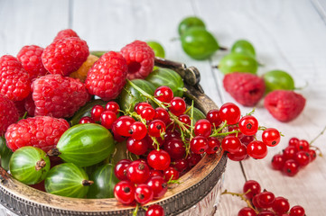 Mix of fresh organic berries isolated on vintage wooden table background