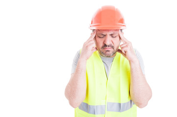 Stressed young constructor having headache or migraine