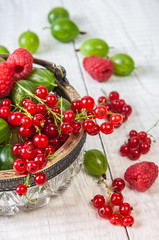 Mix of fresh organic berries isolated on vintage wooden table background