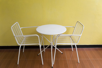 white metal chair and desk beside wall