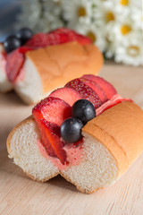 Strawberry slice with flavor cream filled hotdog bread.