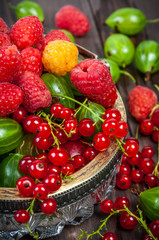 Mix of fresh organic berries isolated on vintage wooden table background
