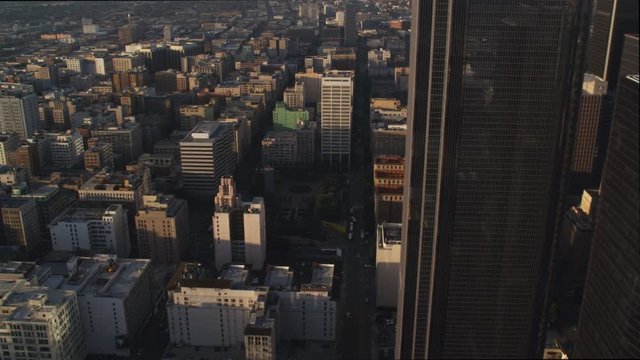 Flying past midsections of Los Angeles skyscrapers to view of Westin Bonaventura Hotel in shadow. Shot in 2010.