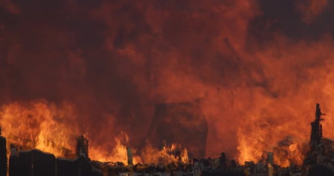 The burning, charred remains of a structure still on fire