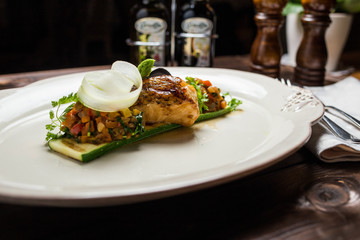 Grilled sea bass fish with vegetables and herbs