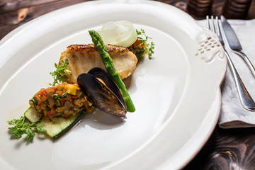 Grilled sea bass fish with vegetables and herbs