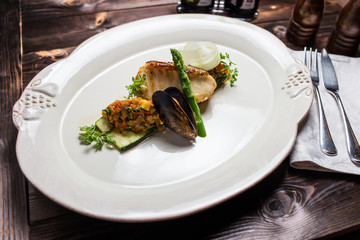 Grilled sea bass fish with vegetables and herbs