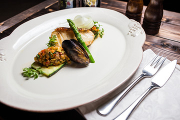 Grilled sea bass fish with vegetables and herbs