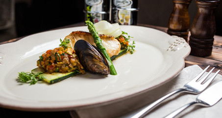 Grilled sea bass fish with vegetables and herbs