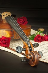 Fototapeta premium Old violin on wooden table. Detail of old violin. Invitation to the Violin Concerto. I love classical music. Sale of antique violins. 