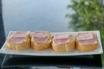 French toast with ham and cheese in dish on black stone table