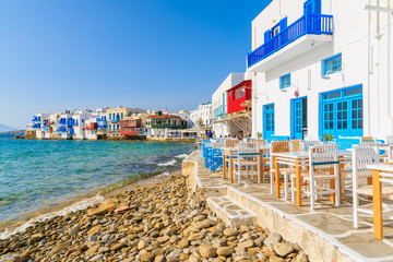 A view of beach and tavern buildings in Little Venice part of Mykonos town, Mykonos island, Greece - obrazy, fototapety, plakaty