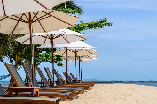 Beach chairs on the beach with blue sky and white umbrella,Koh Samui in Thailand
