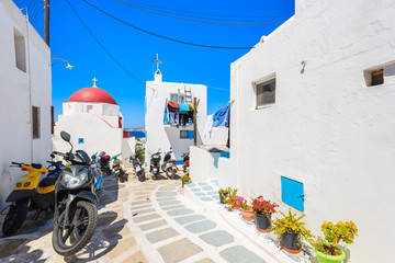 Fototapeta premium MYKONOS TOWN, GREECE - MAY 16, 2016: Scooters parked on street in Mykonos town on island of Mykonos, Cyclades, Greece