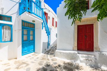 A view of whitewashed street with blue windows and doors in beautiful Mykonos town, Cyclades islands, Greece © pkazmierczak