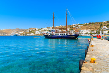 Traditional wooden sailing boat mooring in Mykonos port, Cyclades islands, Greece © pkazmierczak