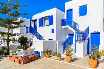 Typical white houses with blue doors and windows on Mykonos town street, Cyclades islands, Greece