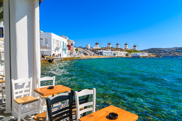 A view of windmills from typical taverna on coast of Mykonos, Cyclades islands, Greece