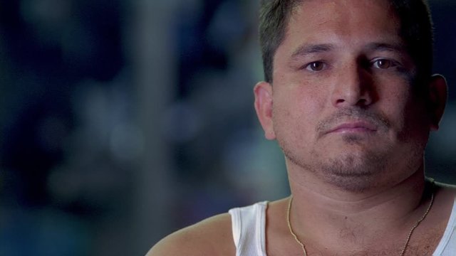 Full-face portrait of man in sleeveless undershirt