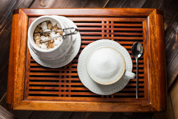 coffee americano with beans on wooden table