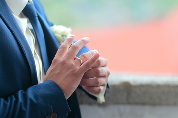 Fototapeta premium Groom touches wedding ring