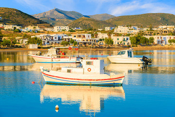 Fishing boats mooring in Naoussa port at sunrise time, Paros island, Cyclades, Greece