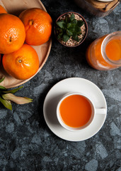 Fresh orange fruits and juice on marble table. Flat lay.
