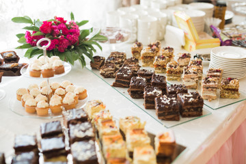 Delicious and tasty dessert table with cupcakes  shots at reception closeup - Powered by Adobe