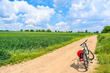 Obraz premium Bicycle on rural road in beautiful summer countryside landscape, Poland