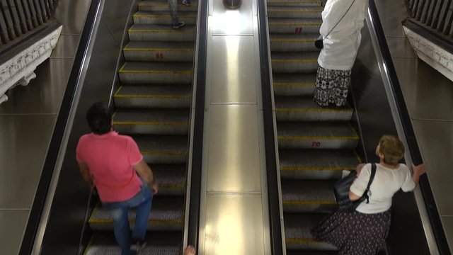 Unrecognizable people on moving staircase of Moscow metro 4K video
