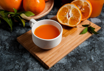 Fresh orange fruits and juice on marble table. Flat lay.