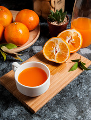 Fresh orange fruits and juice on marble table. Flat lay.