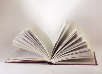 a large open book and the light of knowledge