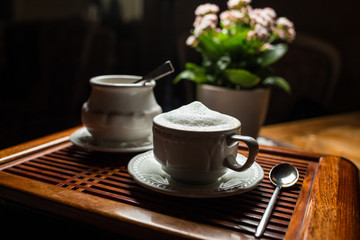 coffee americano with beans on wooden table