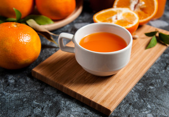 Fresh orange fruits and juice on marble table. Flat lay.