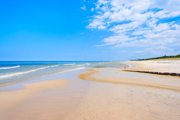 Fototapeta na wymiar A view of white sand beach and blue Baltic Sea, Bialogora coastal village, Poland