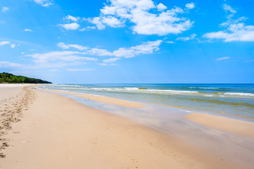 A view of white sand beach and blue Baltic Sea, Bialogora coastal village, Poland