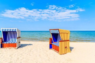 Colorful wicker chairs on sandy Jurata beach, Baltic Sea, Poland