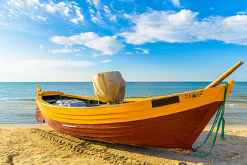 Fototapeta premium Typical fishing boat on a beach in Debki coastal village at sunset time, Baltic Sea, Poland