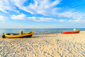 Typical fishing boats on a beach in Debki coastal village at sunset time, Baltic Sea, Poland