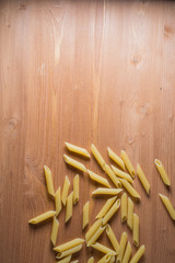 Dried pasta selection on wooden background.