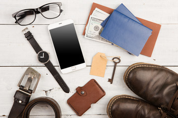 travel concept - set of cool stuff with phone and other things on wooden table