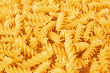 Fusilli Pasta texture background. Pasta is a staple food of traditional Italian cuisine.