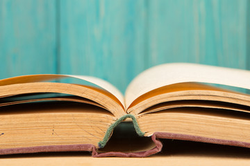 Open book on the desk over wooden background
